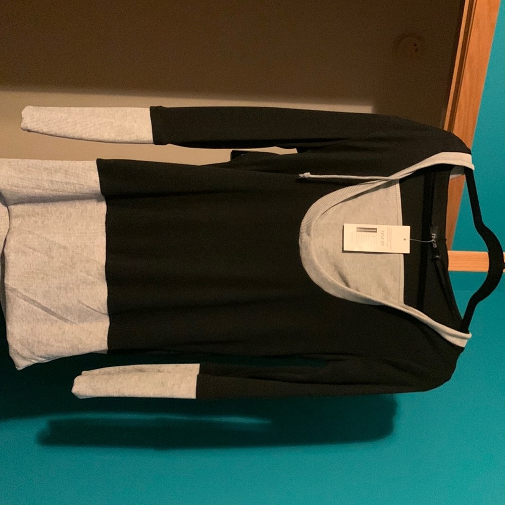 Long sleeve top black and gray.  Never worn. Tag says XL fits like S/M